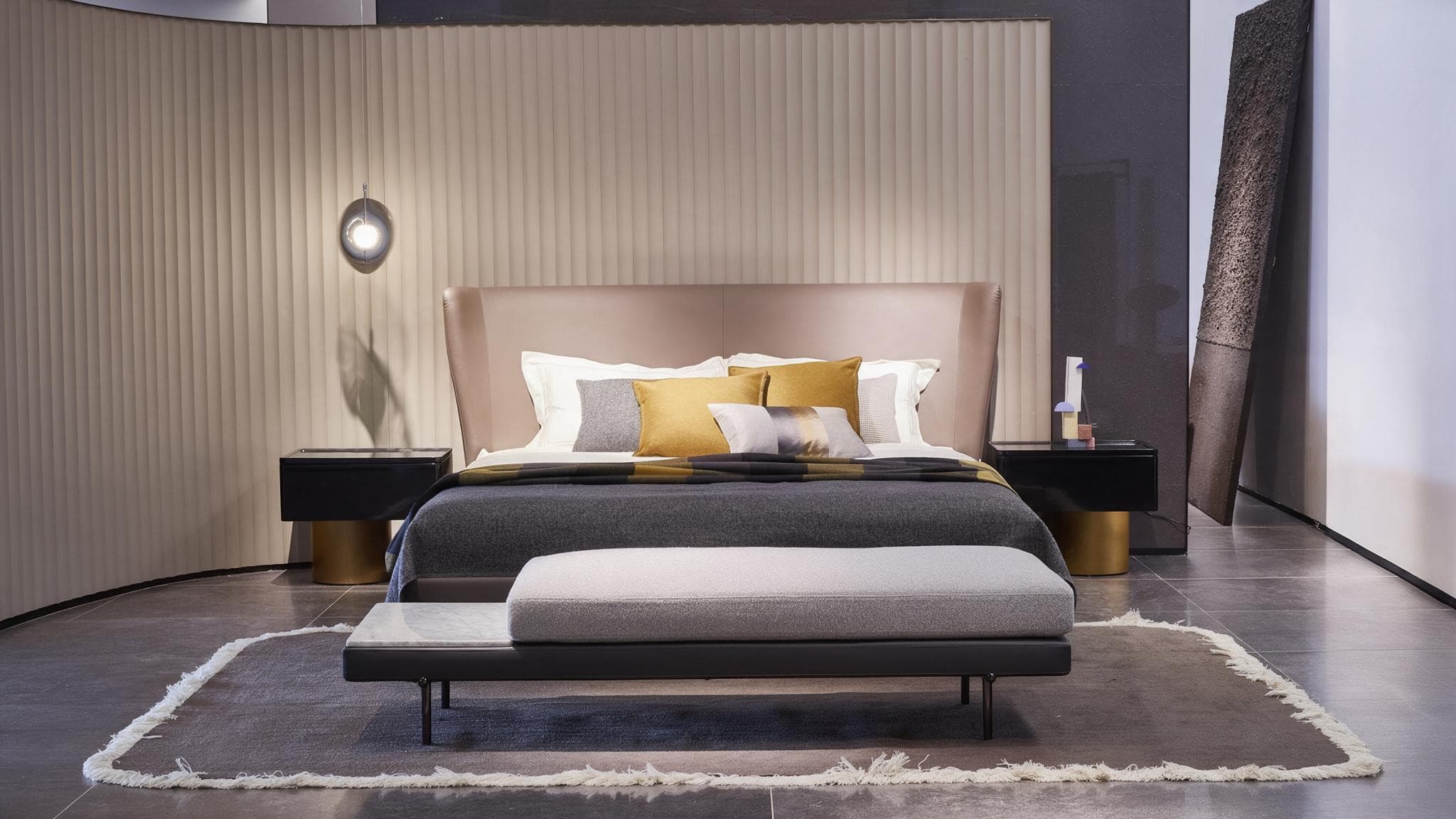 A2312 bed with a blush leather wing headboard, styled with a bench at the foot and a fluted screen behind