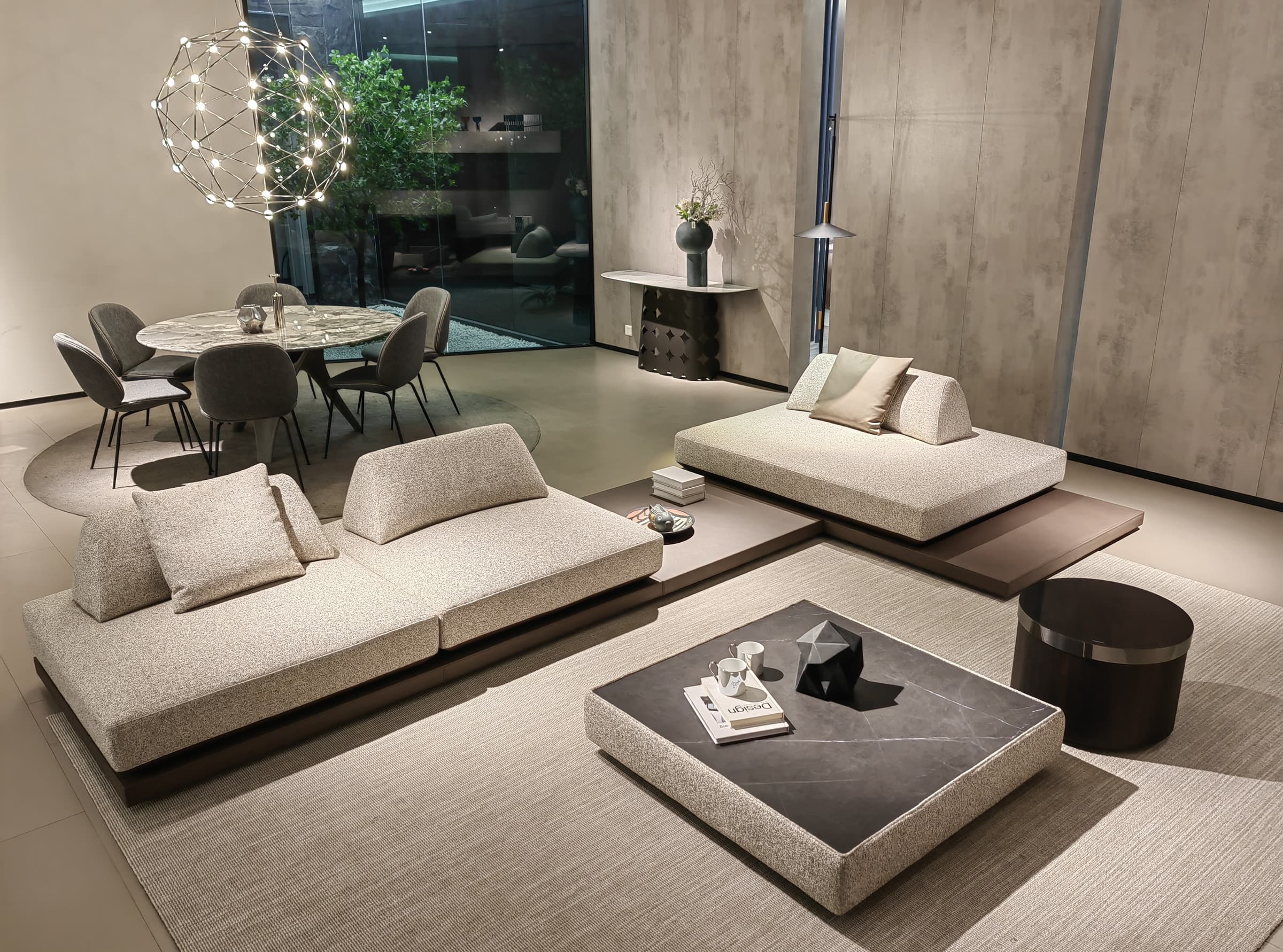 F9719 platform island sofa with boucle seats and wedge backrests facing each other on dark plinth decks